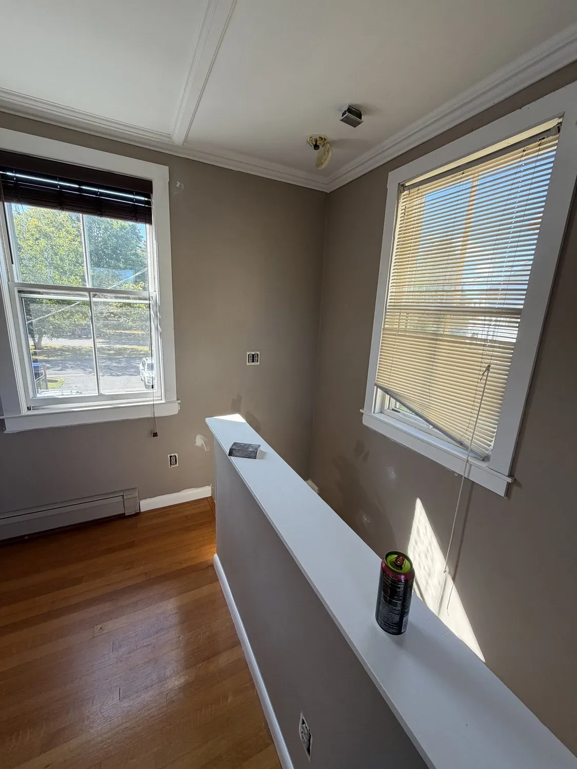 A Danvers living room in warm gray with white trim and a hardwood floor