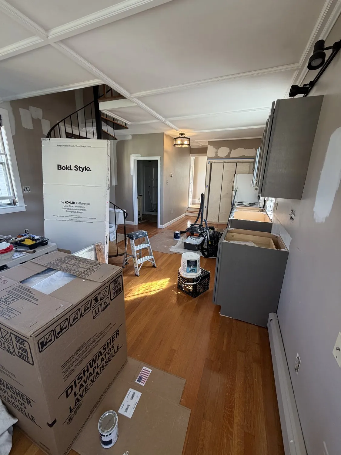 An open-plan Danvers ground floor mid-job, floors protected and materials sheeted