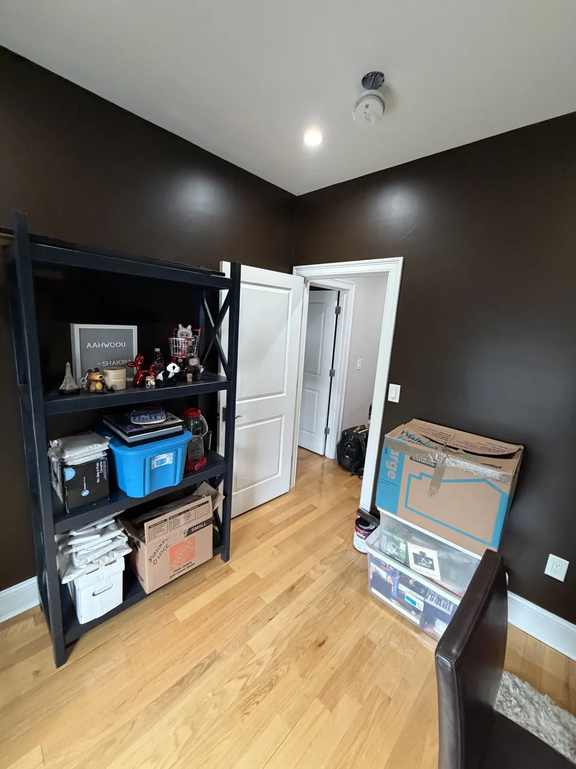 Fitted closet doors in a Dorchester room painted charcoal, with white door frames