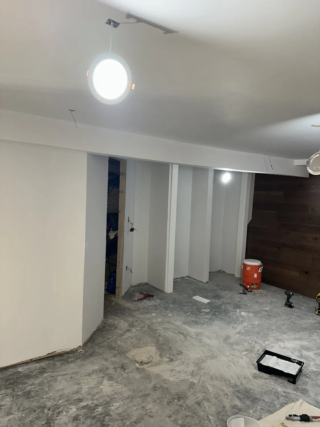A Leominster basement being finished, walls painted and framing still exposed in part