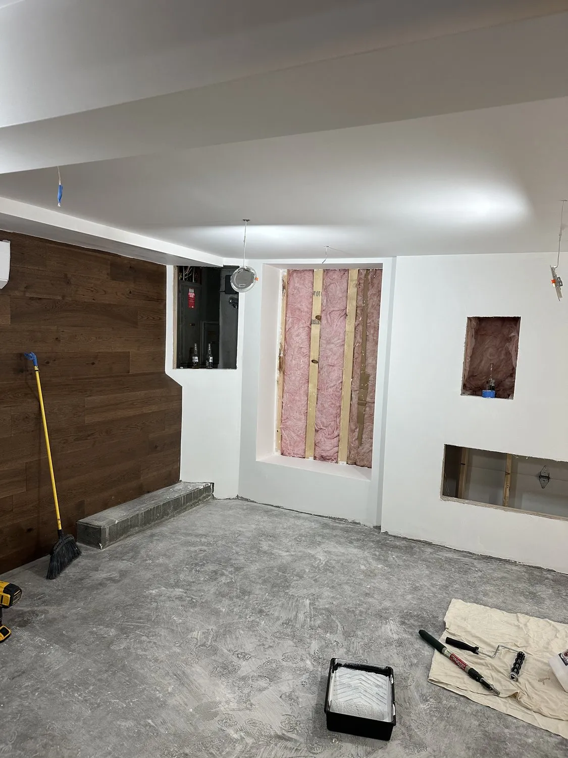 A Leominster feature wall with wood cladding meeting freshly painted plaster