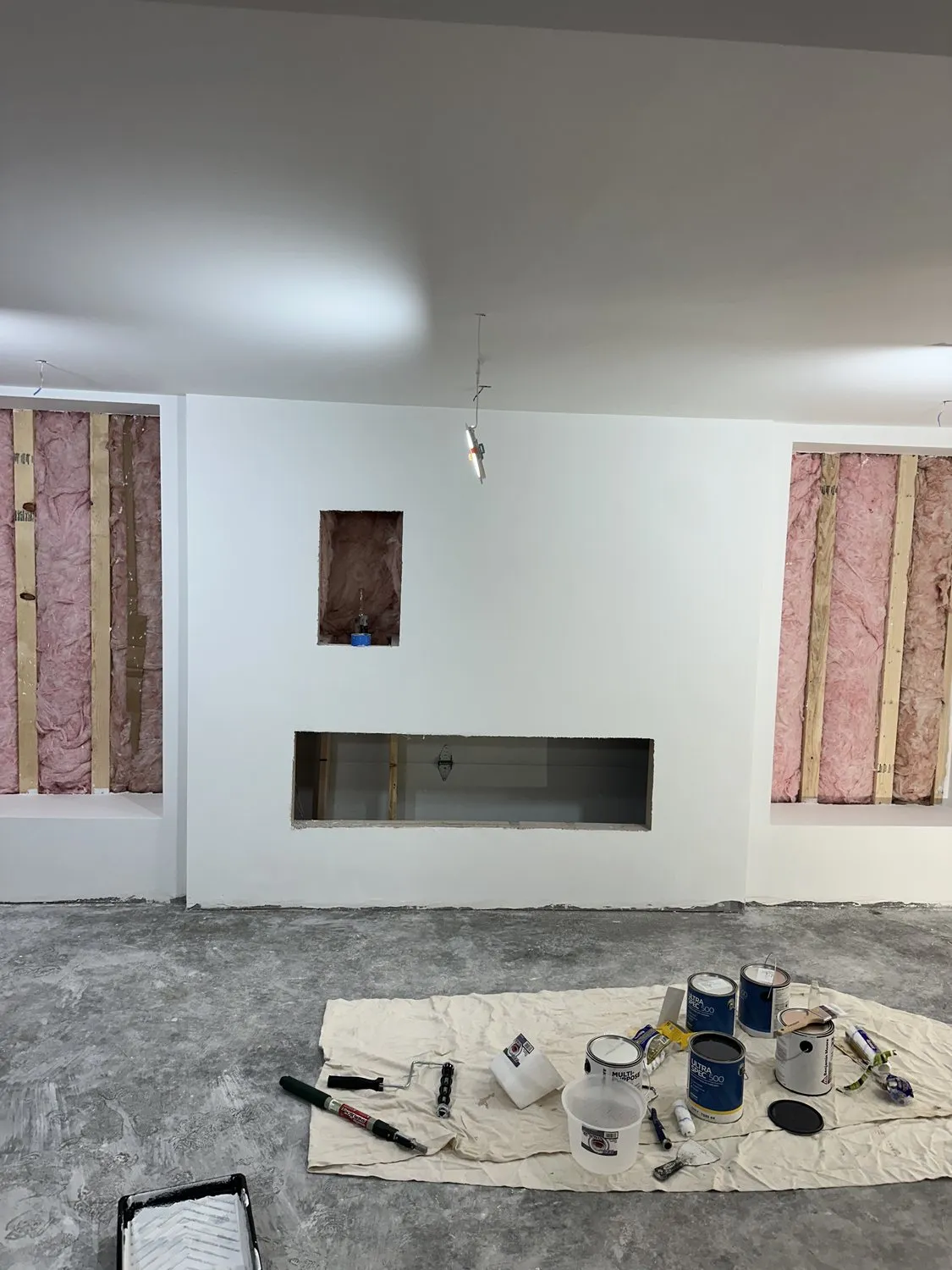 A Leominster room mid-job, walls coated and tools on a drop cloth