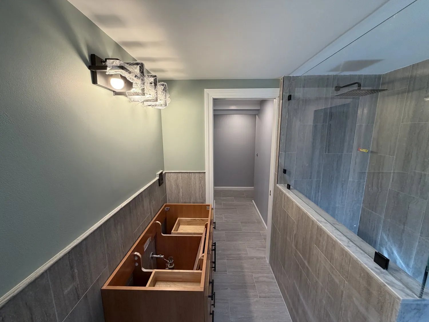 A Norwood bathroom with a tiled shower enclosure and a fitted vanity unit