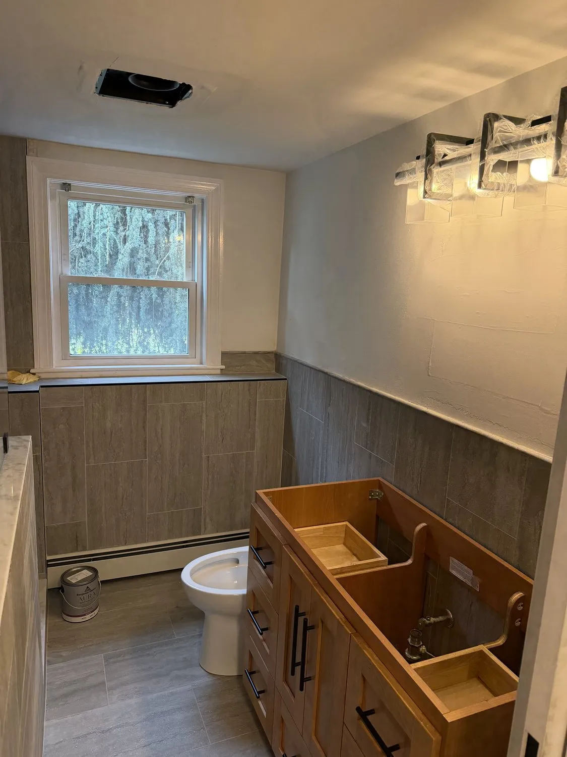 A Norwood bathroom with pale walls over wood-effect wainscot paneling