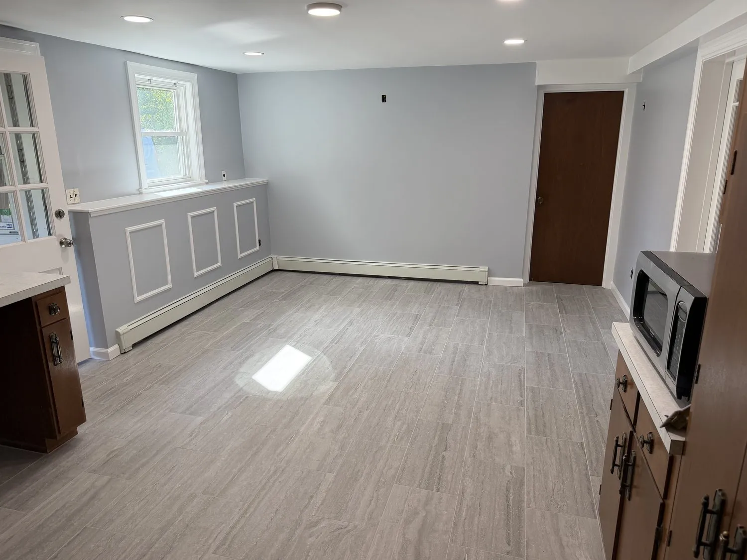 A Norwood dining room with pale blue walls above white wainscot paneling