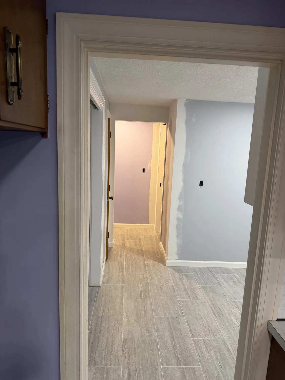 A finished Norwood hallway in pale lilac with white doors