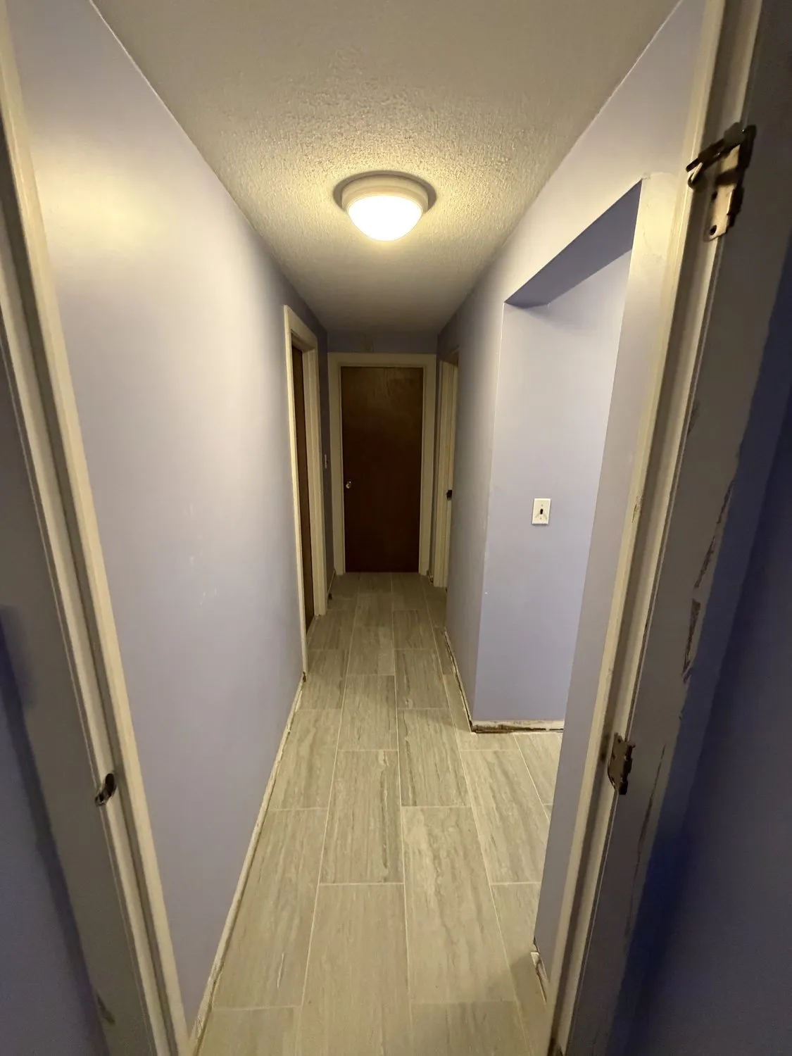 A wide Norwood hallway in pale lilac with white doors and trim
