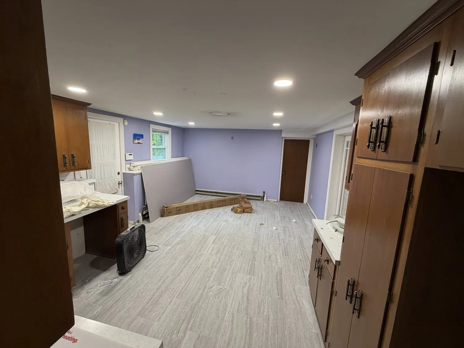 A Norwood kitchen part-way through, walls painted and wood cabinets still in place