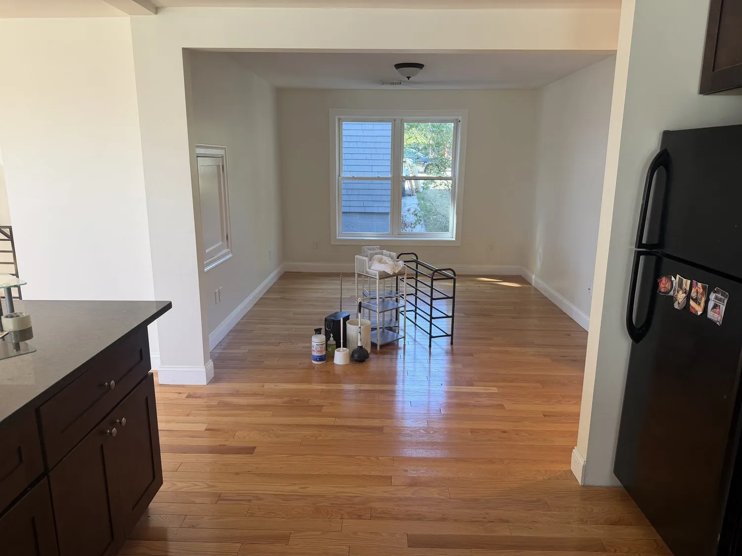 A Roxbury kitchen and dining area painted off-white with a hardwood floor